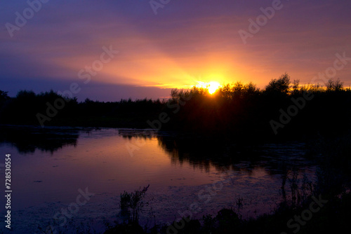 The sun breaks out under cloud cover just before dusk