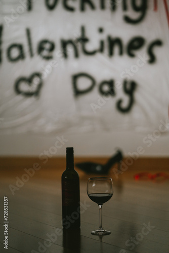 Happy fucking Valentine's day. Bad mood at holidays. A glass of vine and a bottle instead of dating