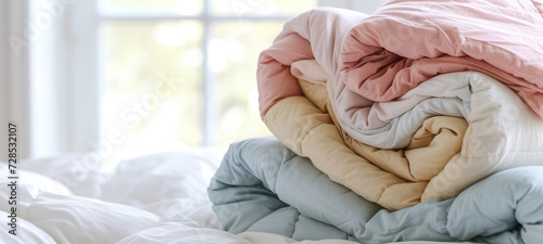 Pastel Folded Linens. Close-up of folded duvet covers, Background for home goods and bedding store. photo