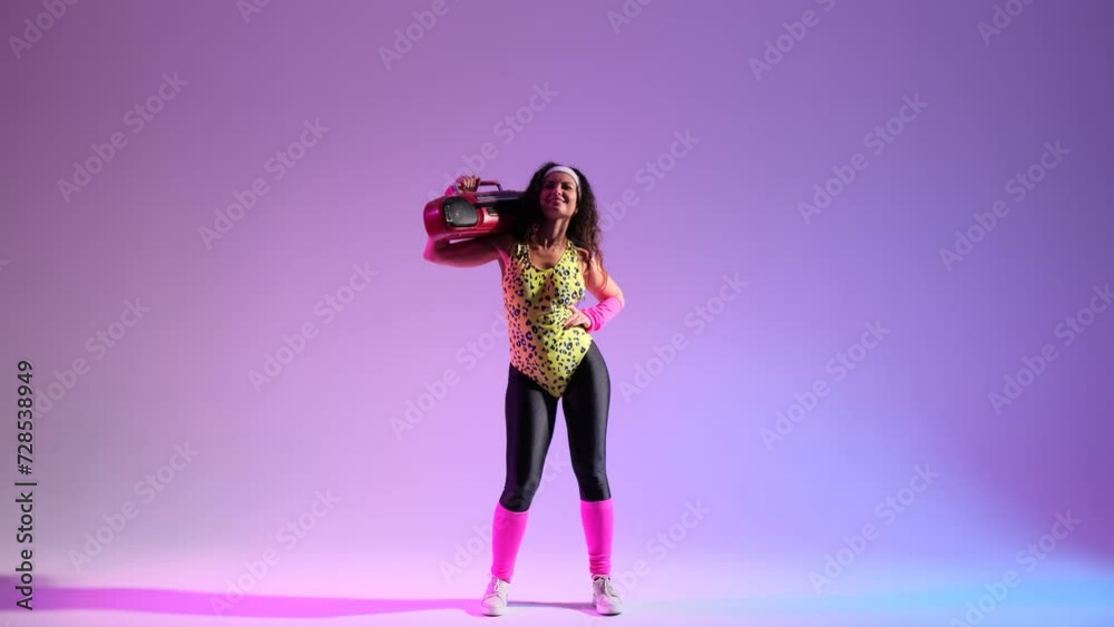 Nerdy woman in a retro ensemble, dances on a vibrant purple backdrop. Holding in hands, a classic boombox, amplifying the atmosphere with a burst of retro energy. Nerdy woman in a retro ensemble, dances on a vibrant purple backdrop. Holding in hands, a classic boombox, amplifying the atmosphere with a burst of retro energy.