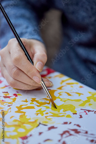 Wallpaper Mural a woman's hand holding a brush and painting on a canvas to learn to paint. Torontodigital.ca