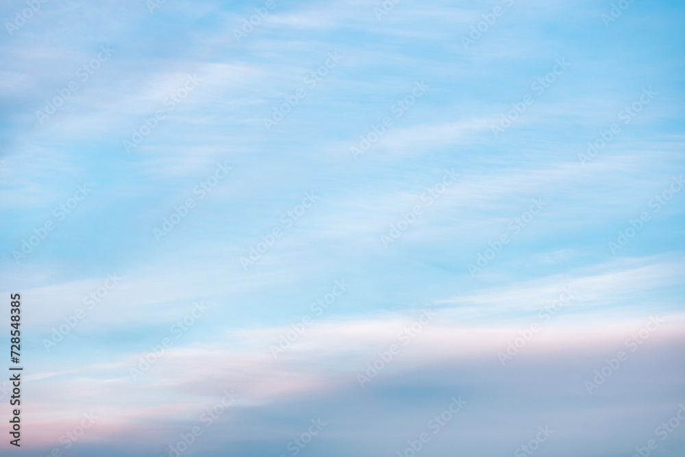 Obraz premium A beautiful sky tinted by the sun leaving vibrant shades of gold, pink, blue and multicolored. Clouds in the twilight evening and morning sky. Cloudy sky background in the evening and during the day.