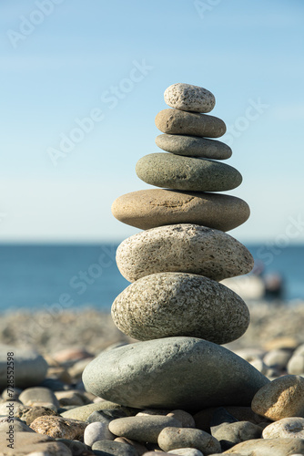 Pyramid of round gray stones on the bank of a mountain river. Zen and harmony concept.Stone tower