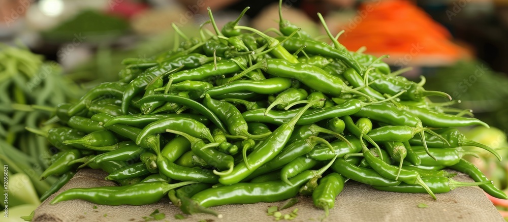 Fresh green chilies available in the market. Fresh green chilies available in the market.