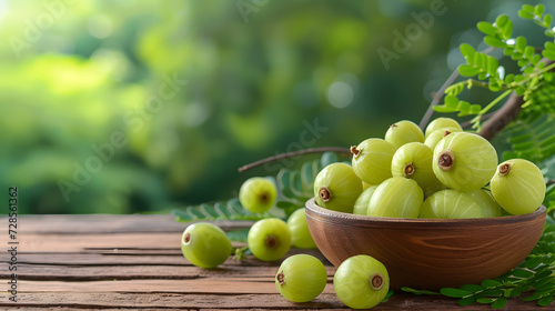 Fresh amla (Indian gooseberry) with wooden bowl isolate on white background 