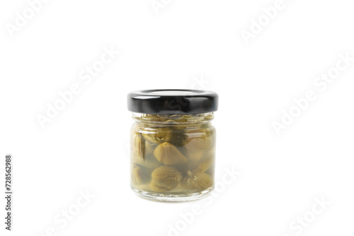 Capers in a glass jar isolated on a white background. Marinated caper buds, small salted capparis in bowl, fermented food, pickled capers group.Organic spices and seasonings.