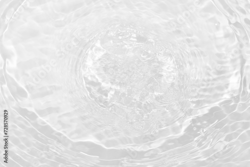 White water with ripples on the surface. Defocus blurred transparent white colored clear calm water surface texture with splashes and bubbles. Water waves with shining pattern texture background.