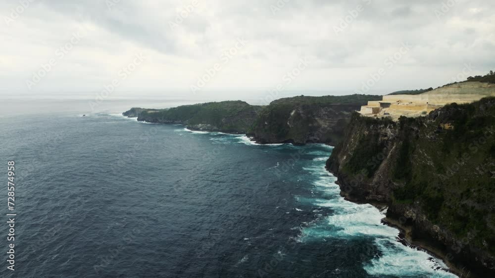 Aerial View of Nusa Penida and the Quarry. Drone View of the Beautiful Island Near the Ocean. Quarrying of Stone in Bali. Traveling Concept Aerial View of Nusa Penida and the Quarry. Drone View of the Beautiful Island Near the Ocean. Quarrying of Stone in Bali. Traveling Concept
