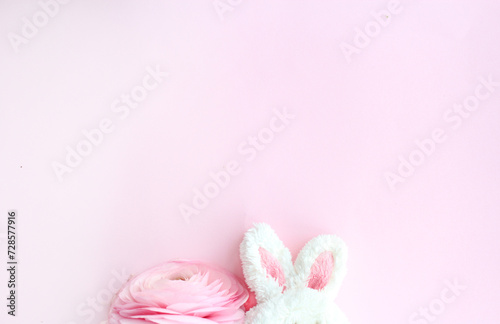 Peekaboo Bunny: A Delightful Close-Up of a Plush Toy Bunny and a Beautiful Pink Flower