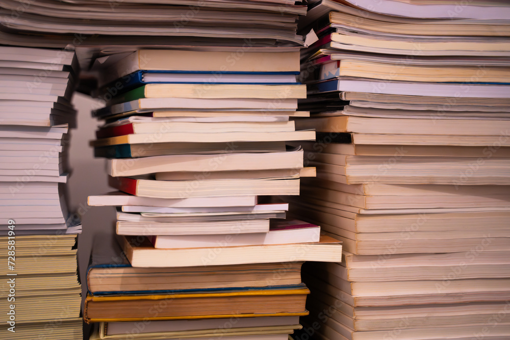 Stacks of large books piled high on top of each other Stacks of large books piled high on top of each other