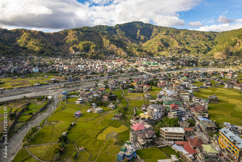 Aerial of the town of Bontoc, the capital of the landlocked province of Mountain Province, in the Cordillera Region of the Philippines. A valley town with terraced rice fields and residential areas. photo