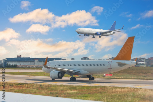 Aircraft is waiting take off, another one lands on the runway. Airport traffic control traffic controllers background sky clouds © aapsky