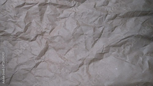 Stop Motion: Fast, chaotic crumpled brown paper texture for documentary background