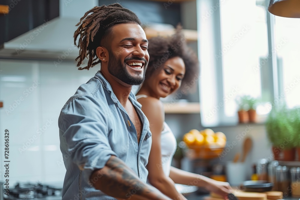 A woman and man stand smiling in their kitchen, the walls adorned with memories and the scent of food filling the room - obrazy, fototapety, plakaty 