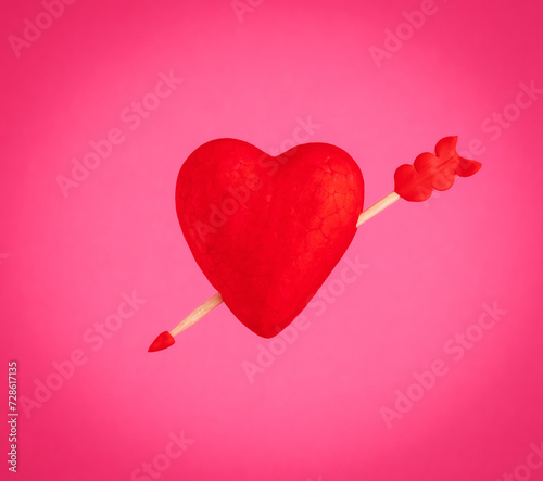 Red heart with arrow on pink background. photo