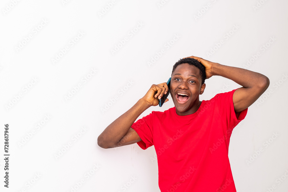 young black man making a phone call looking excited young black man making a phone call looking excited