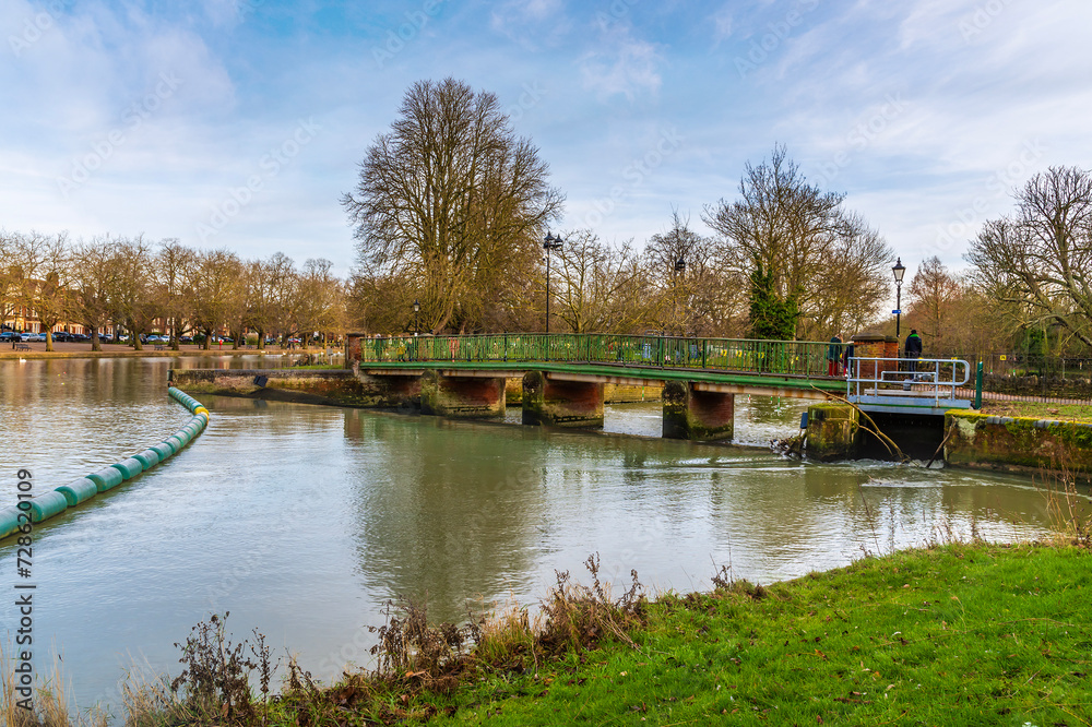 A view towards the Abbey Bridge on the River Great Ouse in Bedford, UK on a bright sunny day