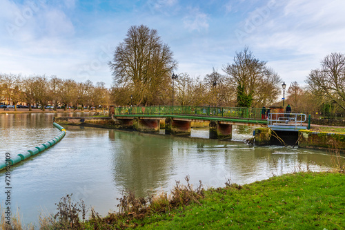 A view towards the Abbey Bridge on the River Great Ouse in Bedford, UK on a bright sunny day © Nicola