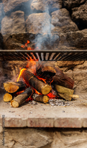 Firewood burning on barbecue for grilling