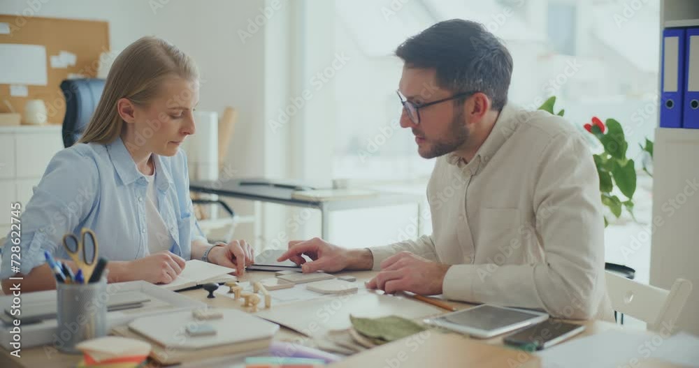 Interior Designers Working At Desk In Office Planning Interior Design. Interior Designers Working At Desk In Office Planning Interior Design.