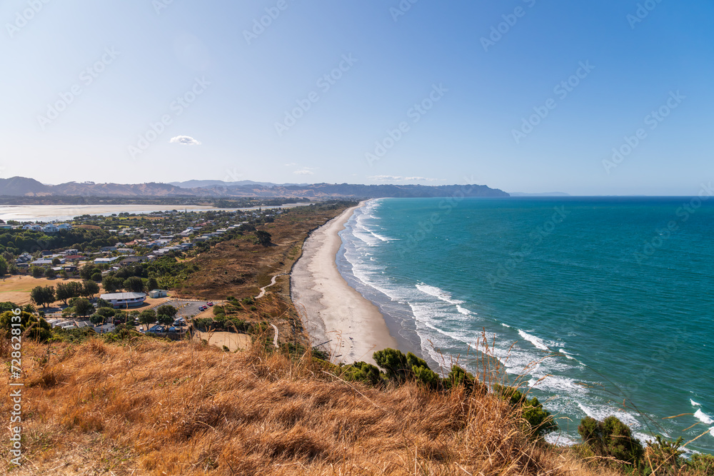 Sunny summer day at Waihi Beach, New Zealand. Ideal for travel brochures, vacation advertisements, or any project seeking to capture the beauty of coastal landscapes and serene beach destinations.