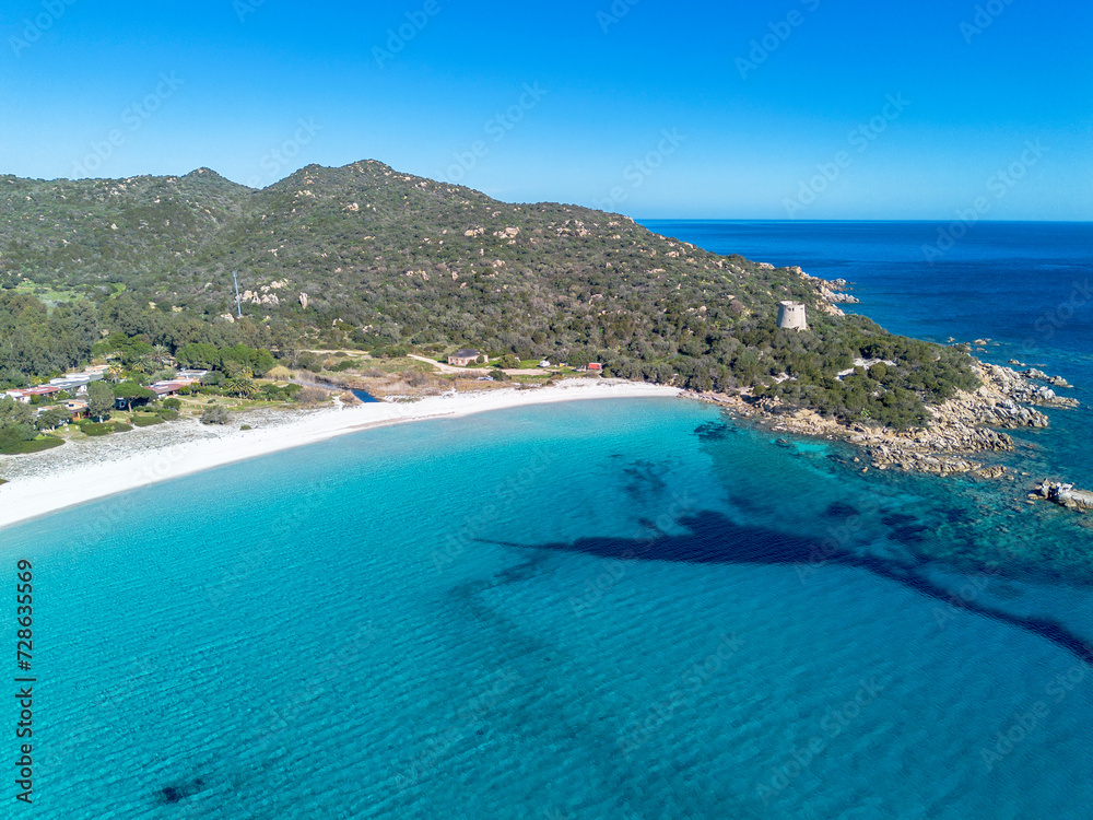 Cala Pira beach and tower, with white sand and crystal clear water seen from above with drone. Castiadas, Sardinia, Italy