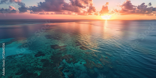Great Barrier Reef on the coast of Queensland  Australia seascape. Coral sea marine ecosystem wallpaper background at sunset  with an orange purple sky in the evening golden hour