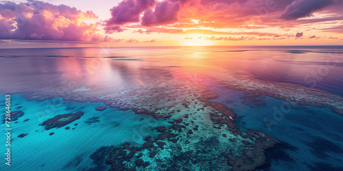 Great Barrier Reef on the coast of Queensland, Australia seascape. Coral sea marine ecosystem wallpaper background at sunset, with an orange purple sky in the evening golden hour