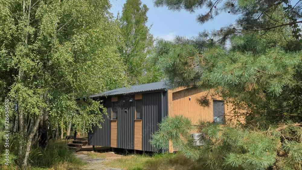 Wooden scandinavian house. Forest cabin in the middle of a forest in silence Wooden scandinavian house. Forest cabin in the middle of a forest in silence
