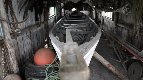 Relic. Shifting the focus along an old and traditional wooden boat inside the wooden shed.