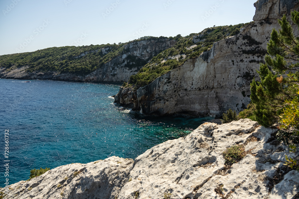 Obraz premium Blue caves in zakynthos, Greece. Potamitis Dive Spot, Zakynthos, greece. Skinari View Point. Blue Caves located between Aghios Nikolas and Cape Skinnari. Turquoise ionian sea in greek island.