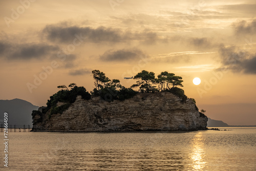 Plane lands against the background of the Greek islands. Greek island with wooden bridge. Cameo island in Greece. Sunrise on Cameo island in Greece. Cameo Wedding Island in Zakynthos, Greece.