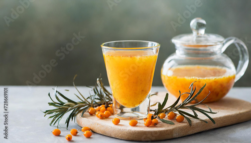 Healthy sea buckthorn tea in glass cup, selective focus