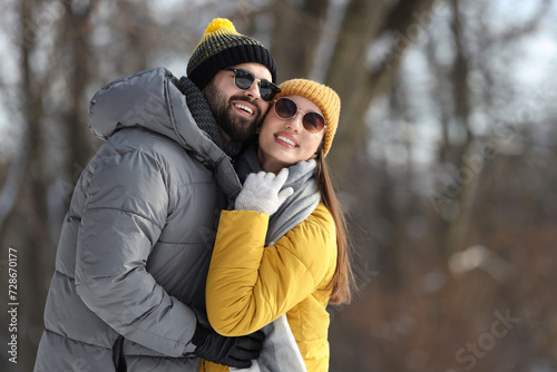 Beautiful happy couple outdoors on winter day. Space for text
