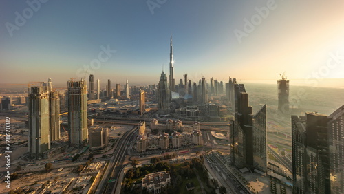 Aerial view of tallest towers in Dubai Downtown skyline and highway timelapse. © neiezhmakov