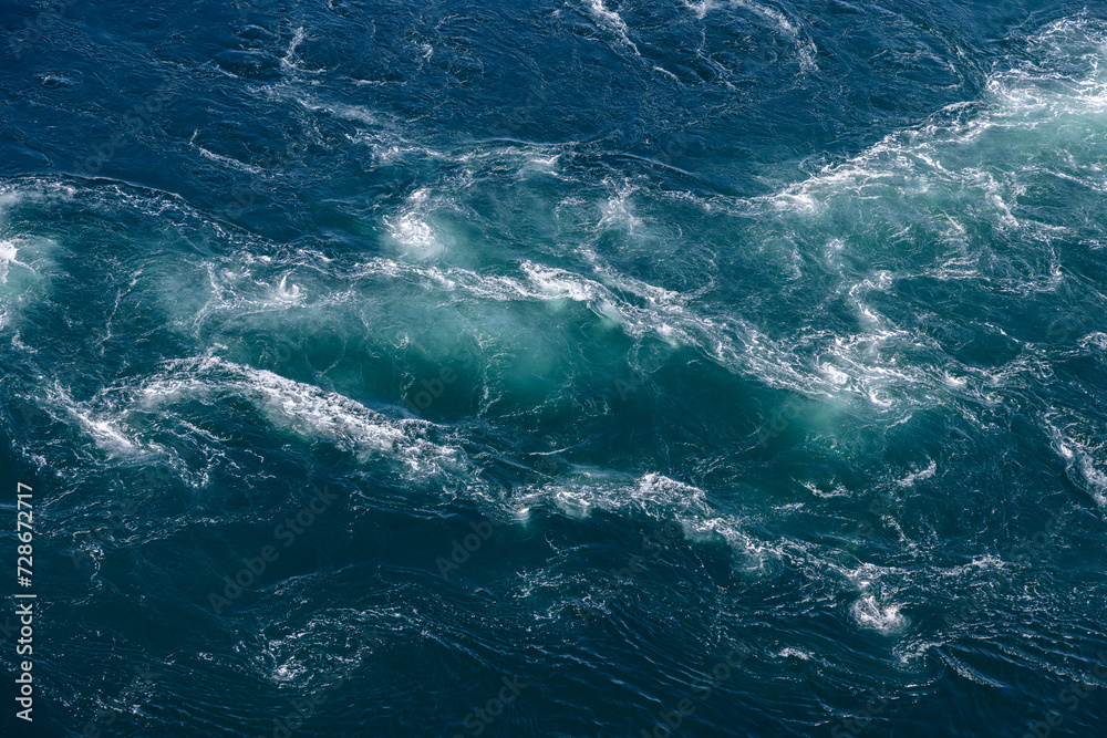 Fototapeta premium The Saltstraumen current carves intricate patterns in the sea, ideal for a background with its mesmerizing aquatic textures