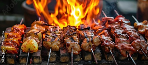 Assorted meats on skewers, grilled over charcoal and fire, in traditional street food style, Generative AI