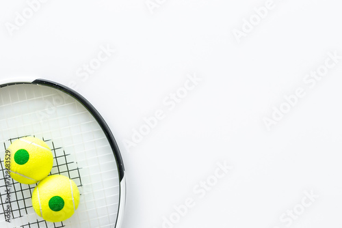 Close up of tennis racquet and balls, top view. Sport games background © 9dreamstudio