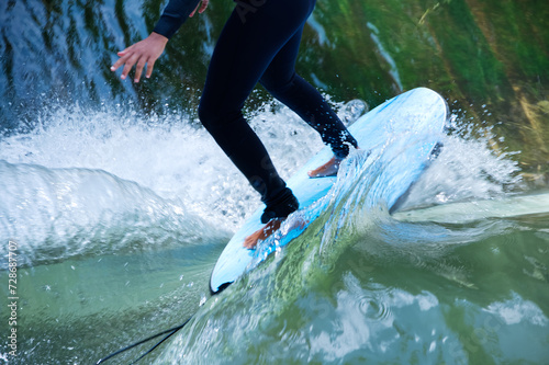 Photography Bodypart of a surfer surfing on the flowings water