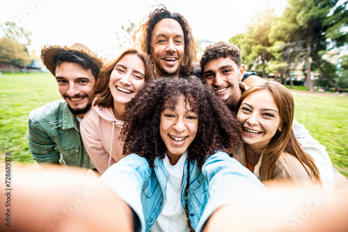 Multiracial friends taking selfie picture with smart mobile phone outside - Group of people smiling at camera outdoors a nature - Friendship concept with guys and girls enjoying wilde summer vacation