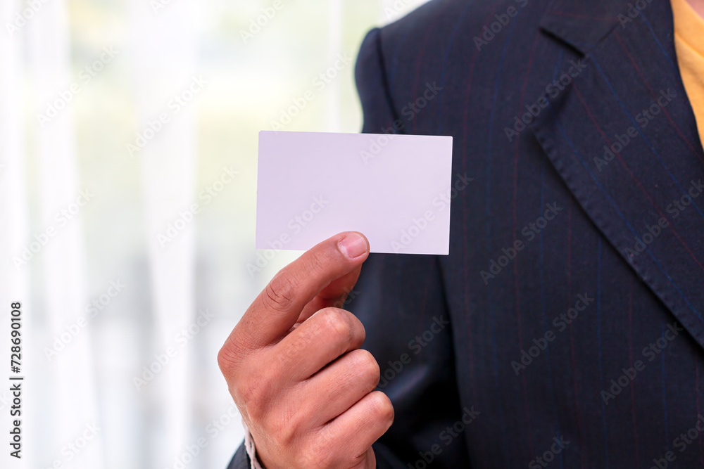 Close-Up of Businessman Holding Blank Card with copy space;Identity and Professionalism Close-Up of Businessman Holding Blank Card with copy space;Identity and Professionalism