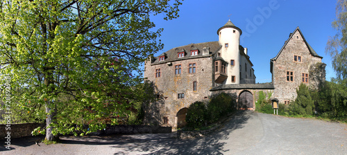 Panoramic view of Neuerburg castle with medieval tower and Renaissance oriel window, Eifel region in Germany photo