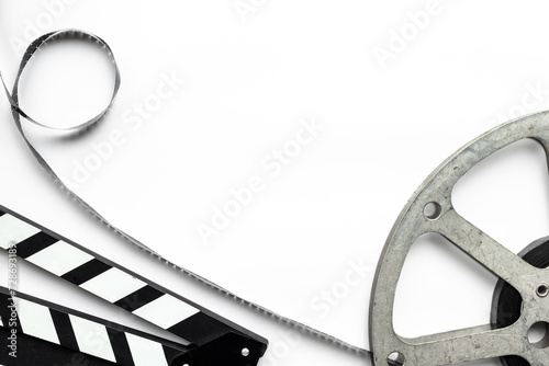 Cinema and filmmaker concept with film reels and clapperboard photo