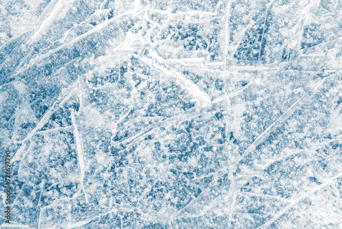 Ice texture background. The textured blue cracked rough cold frosty surface of the ice background.