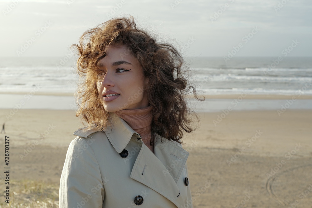 Portrait of a beautiful young woman standing on the beach