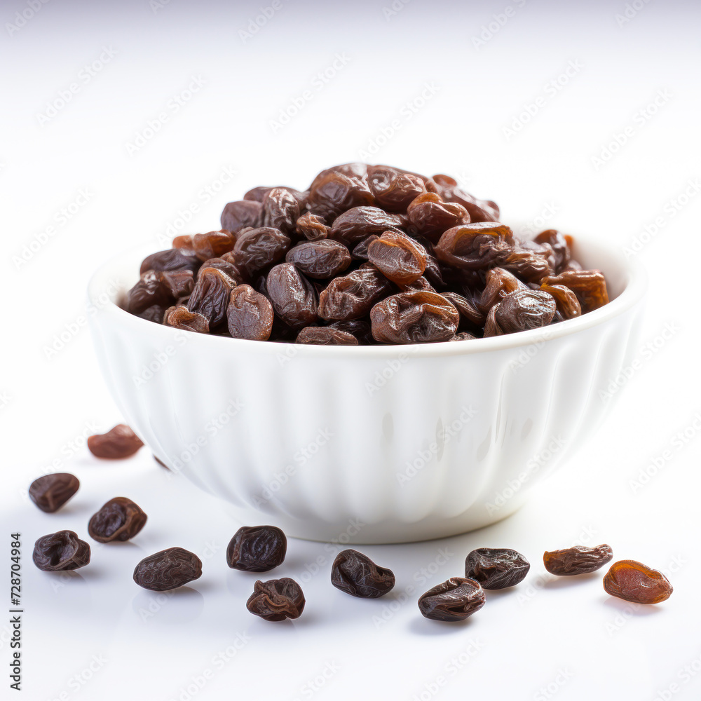 black raisin in wooden bowl on white background black raisin in wooden bowl on white background