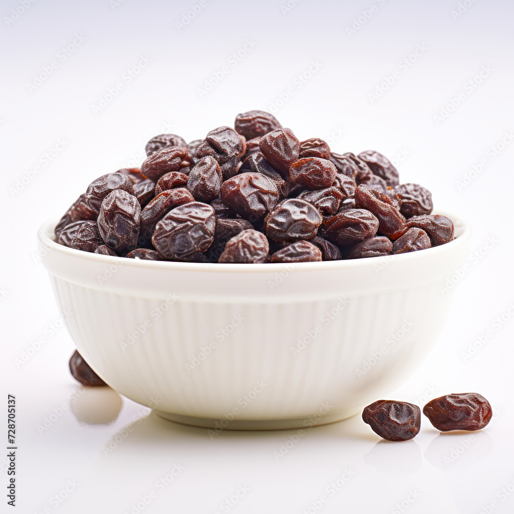 black raisin in wooden bowl on white background black raisin in wooden bowl on white background