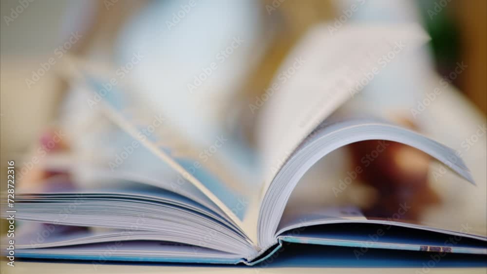 Woman reading a book at a coffee shop close up Woman reading a book at a coffee shop close up