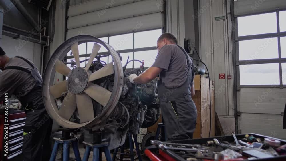Mechanics are servicing and repairing a motor Mechanics are servicing and repairing a motor