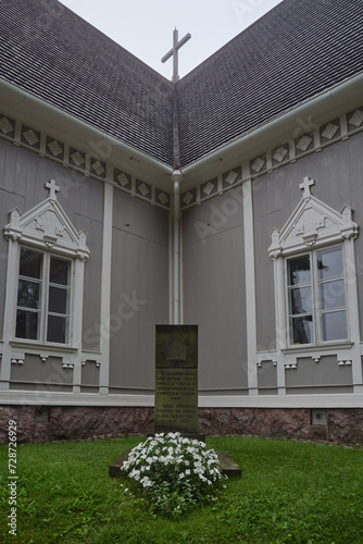 Monument next to the old Lutheran church in Tuusula, Finland. Translation of the inscription on the monument: Our ancestors built the first church of the Tuusula parish on this site in 1643. photo